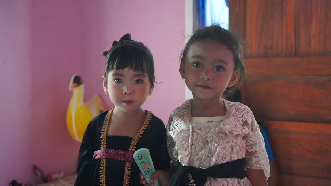 Two little girls standing next to each other