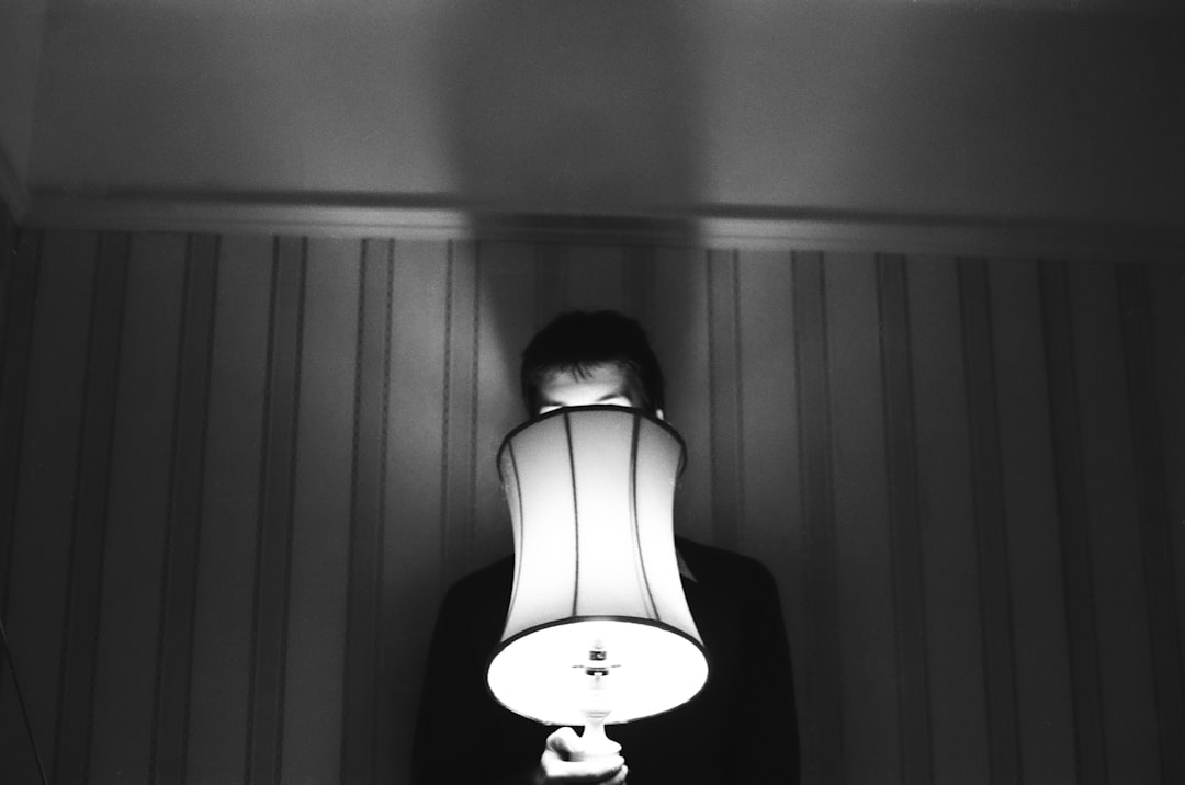 a person holding a lamp in front of their face
