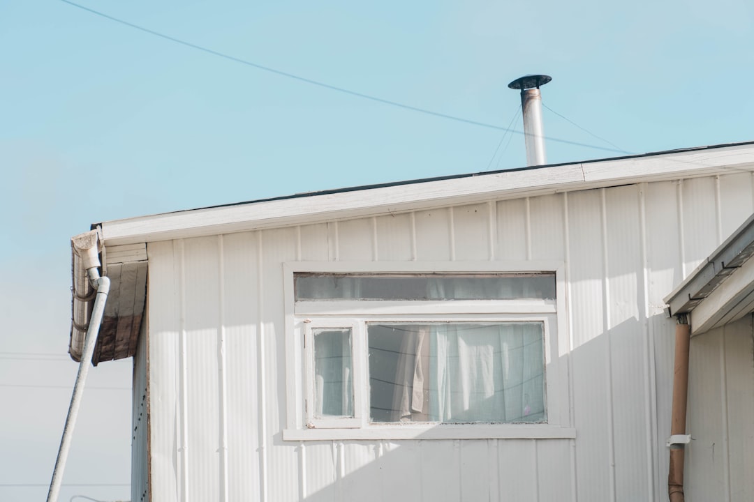 a white house with a window and a ladder