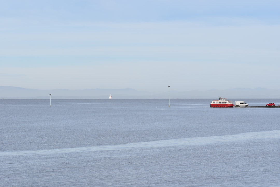 a large body of water with a boat in the distance